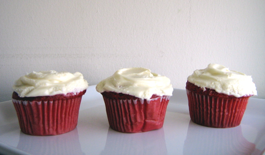 red velvet cupcakes with cream cheese on top